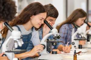 Pictured:  Students looking into microscopes